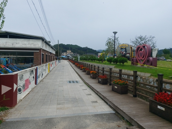 마을 담장에는 이현세만화벽화가, 개울을 따라서는 꽃으로 가득한 화분들이 줄지어 있는 매화마을.